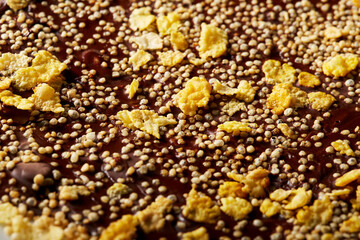 Chocolate bark with puffed quinoa and cornflakes on parchment