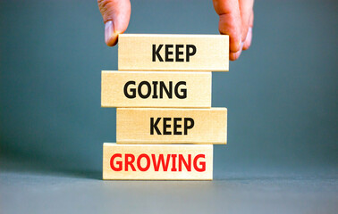 Keep going and growing symbol. Concept words phrase Keep going keep growing on beautiful wooden...