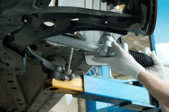 Repair and replacement of the steering rack. The car mechanic replaces the faulty one and then installs a new steering rack on the car.
