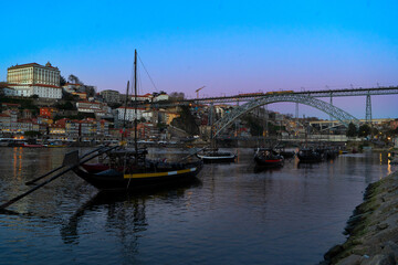Picturesque, colorful view at old town Porto at sunset over Douro river. Oporto, touristic mediterranean city