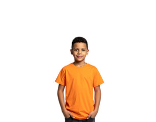 Fototapeta premium Smiling boy in orange tshirt with hands in pockets portrait view
