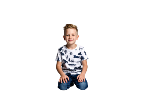 Smiling boy with blonde hair kneeling in jeans and a patterned shirt