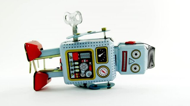 Wind up toy robot on his side isolated on white 