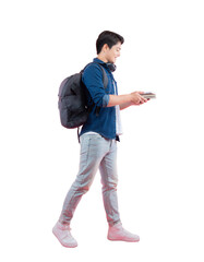 Full body image of young Asian male student holding book , wear backpack and posing on PNG background	