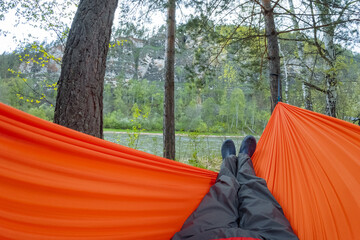 Imagine spending a delightful afternoon relaxing in a vibrant orange hammock, gently swaying amidst...
