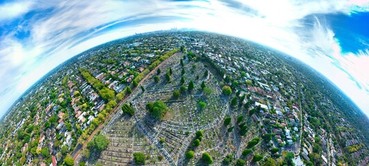 Naklejka premium Aerial view of the Boroondara General Cemetery in Kew, with the Melbourne city skyline in the background, Victoria, Australia. March 2025
