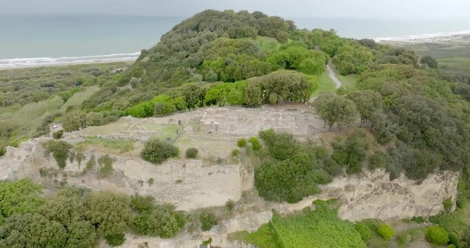 Aerial view of the archaeological excavations of Cuma, in the province of Naples, Campania, Italy. On the hill are the remains of the ancient city of Cumae, one of the oldest Greek colonies in Italy.