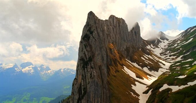 Majestic mountain peaks rise dramatically against a clear sky in Switzerland during summer