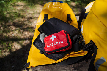 A wellstocked first aid kit is conveniently located in a bright yellow bag, making it easy to...