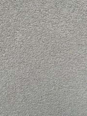 Roughcast surface. Grunge texture as background. Bumpy gray exterior wall with small frequent cracks. Rugged coarse cement or concrete rendering. Painted pebble dash. Uneven structural plaster finish.