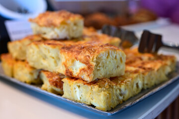 Bakery .Home made  cheese pie  with phyllo pastry, feta cheese  and organic eggs. Bulgarian banitsa. Brekfast on a display at Hotel