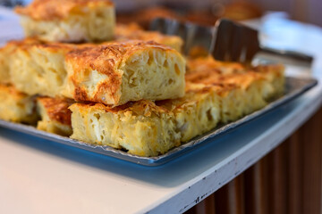 Bakery .Home made  cheese pie  with phyllo pastry, feta cheese  and organic eggs. Bulgarian banitsa. Brekfast on a display at Hotel