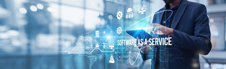 A businessman using a tablet analyzes Software as a Service (SaaS) and evaluates cloud-based subscription revenue growth metrics, customer acquisition trends, scalability potential, recurring revenue.