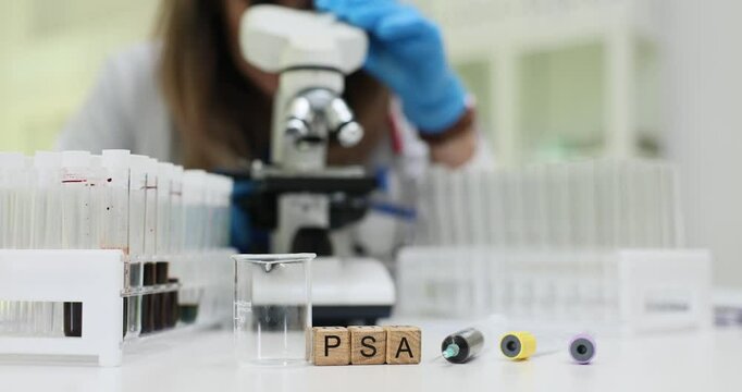 Medical professional analyzes prostate specific antigen PSA test results under microscope in laboratory. Focus on cancer diagnostic processes