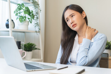 Body muscles stiff problem, ache asian young woman, girl pain neck while sitting work on chair at...