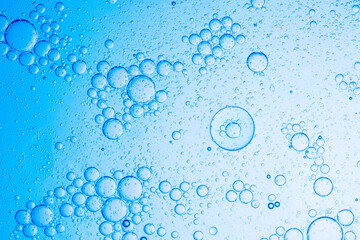 Close-up blue macro bubble texture,Effervescent fizz and clean cosmetics hygiene or rejuvenate renewable energy. Studio shot of transparent cosmetic blue gas bubbles under water in full-frame macro 