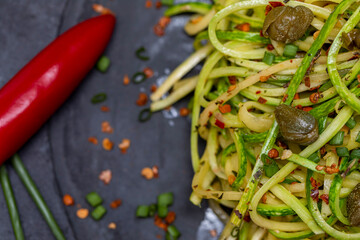 Zucchini spaghetti with dehydrated pepperoni pepper and capers