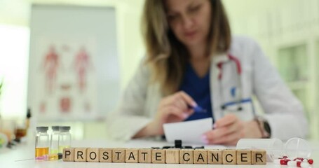 Text Prostate Cancer on wooden cubes and doctor checking test results in clinic. Woman oncologist works with documents and medications in hospital