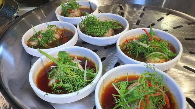 A pot of fish congee is simmering, releasing steam. High quality 4k footage