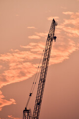 Crane truck working in construction site with sky background. Crane against sky. Crane, Construction background, construction equipment crane background.