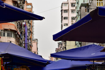 Close-up of the outdoor tents in the street in Hong Kong. Market in the street. Cityscape and urban scene.