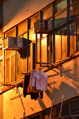 Close-up of the residential building in Hong Kong at night. Building exterior. Hong Kong cityscape, street scene. Travel and cityscape concept.