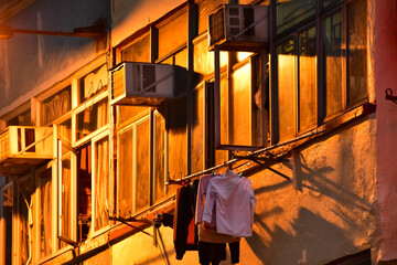 Close-up of the residential building in Hong Kong at night. Building exterior. Hong Kong cityscape, street scene. Travel and cityscape concept.
