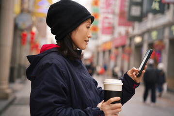 Urban Asian Woman Using Smartphone Outdoors