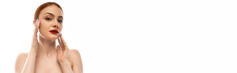 Fototapeta premium Beautiful young woman showcasing radiant skin with confident expression in minimal setting