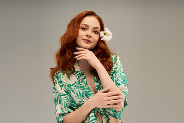 Captivating young woman exudes beauty with tropical flair and a flower accent in serene setting