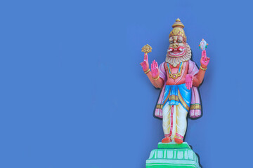 Divine Lord Narasimha Statue on Purple Wall Background