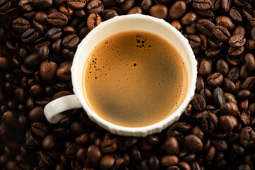Coffee cup with espresso  and roasted coffee beans.