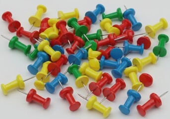 Scattered colorful push pins stationary items