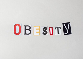 The word obesity is written in a collage, disordered way