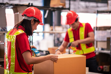 Factory worker,Shipping Team in Distribution Warehouse Packing Products for Delivery with Colleague Support