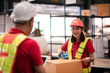 Factory worker,Shipping Team in Distribution Warehouse Packing Products for Delivery with Colleague Support