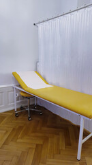 hospital couch behind a white screen for examining patients