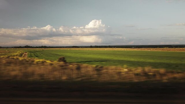 Amazing nature, landscape from the train window, fields, panorama, horizon, view, train ride, tourism, agriculture, vegetable gardens, countryside, dynamics, movement, nature, culture, sunny, clouds