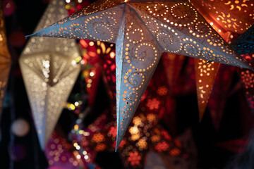 Close-up of colorful Christmas lanterns hanging at a Christmas market. The lanterns are lit from the inside.