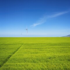 Obraz premium Wind Turbine in Green Field Under Clear Blue Sky 