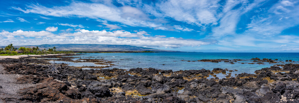 Ultra widescreen panoramic view of black volcanic basalt rock flats on the Kohala Coast of the Big Island of Hawaii.