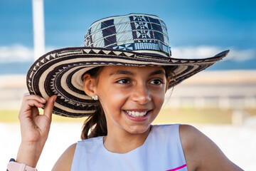 Beautiful young girl tourist wearing a sombrero vueltiao in Cartagena. Colombian people. Travel concept.