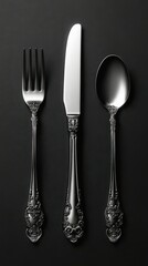 Elegant silverware set arranged neatly on a dark background highlighting fine craftsmanship and design