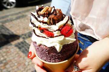 Chimney cake (Kürtőskalács) filled with ice cream, chocolate and red fruits