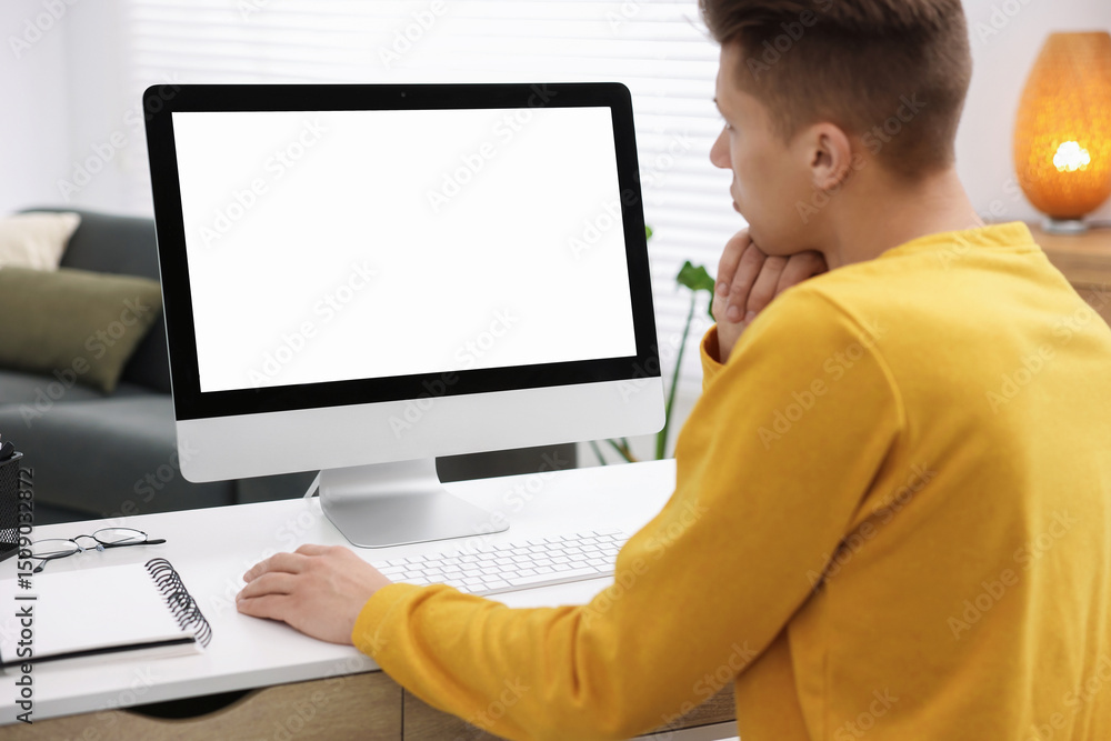 Poster man working on computer at white desk in office. mockup for design