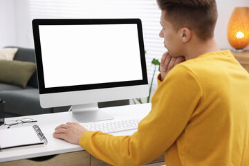 Man working on computer at white desk in office. Mockup for design