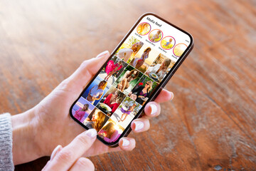 Woman viewing social media photo gallery on mobile phone