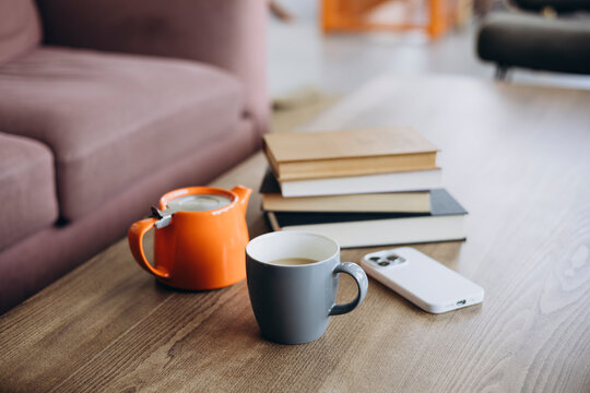 Cozy reading corner with books and tea setup