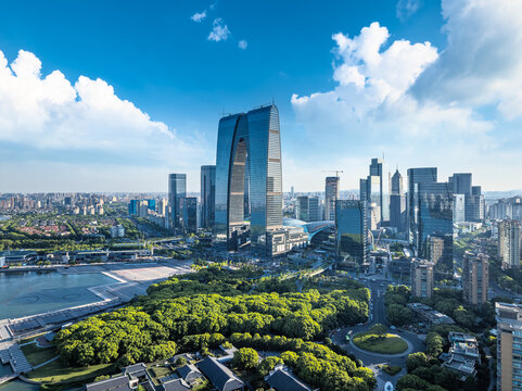 Modern city skyline and skyscrapers, green spaces, and urban roads in Suzhou, China.