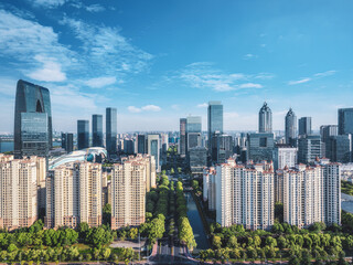 Fototapeta premium Panoramic of modern city skyline with a canal on a bright day in Suzhou, China. Urban background.